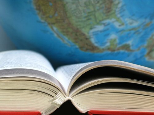 An open book in front of a map