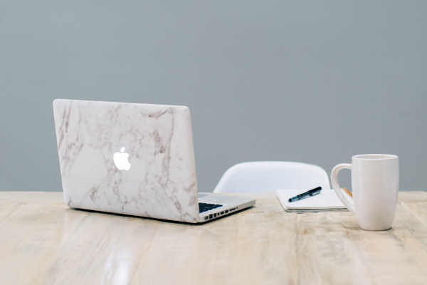 Macbook and coffee cup